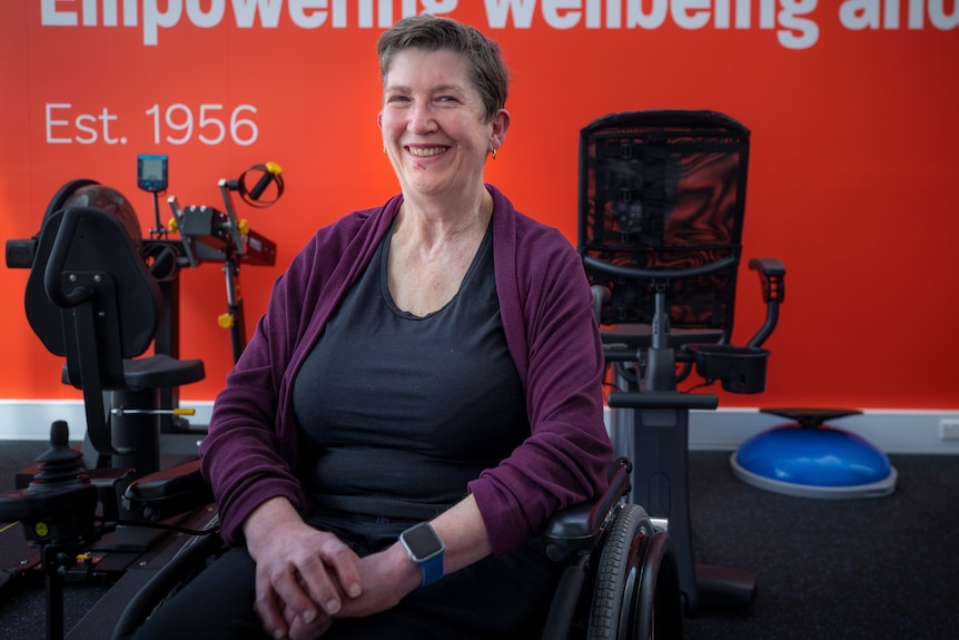 A woman in a wheelchair at a specialised gym for people with multiple sclerosis.