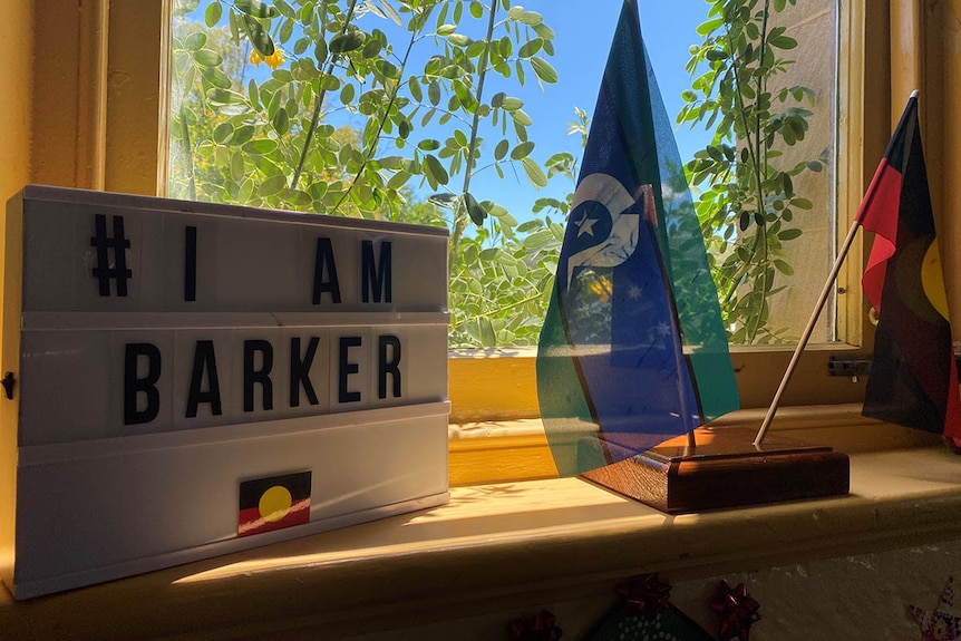 Aboriginal and Torres Strait Islander flags on display inside Barker College next to a lightbox with the words I Am Barker