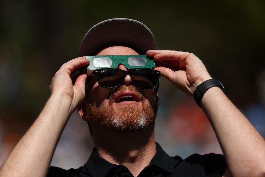 A man wearing special glasses over his eyes. 