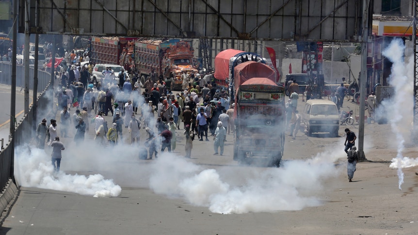 Police and people clash as tear gas fills the street