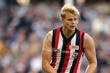 Nick Riewoldt of the Saints runs with the ball in hand (action pic)