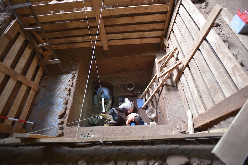 Researchers excavating a trench