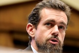 A close-up of Twitter CEO Jack Dorsey looking on in a committee room