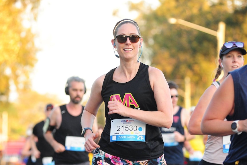 A woman runs in a half marathon event