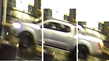 A still from CCTV of a silver ute with its headlights on.