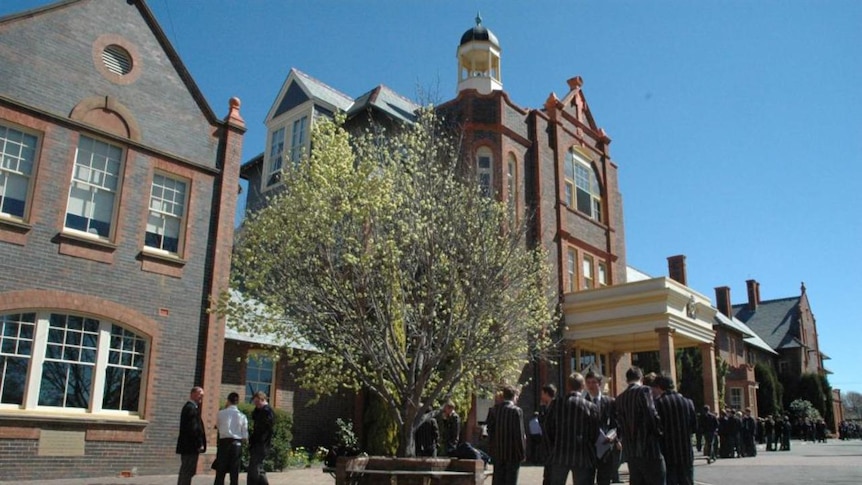 Students stand outside the school.