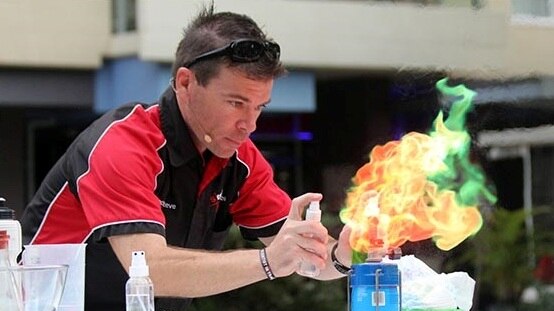 Brisbane science entertainer Steve Liddell creates a large glowing flame during a science demonstration.