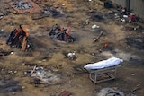 From above, you look at a vacant dirt lot with multiple funeral pyres alight in it. 