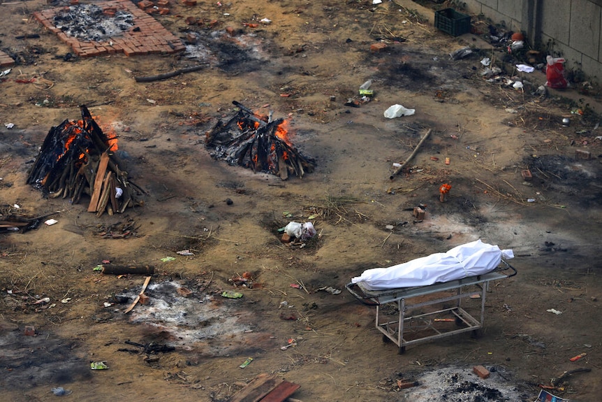 From above, you look at a vacant dirt lot with multiple funeral pyres alight in it. 