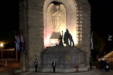 A war memorial illuminated on Anzac Day.