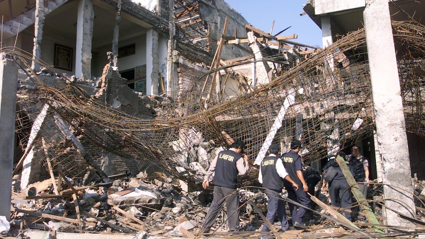 A building stands burnt out with its scaffolding exposed at the site of the bombing in Kuta beach, Bali, October 2003.