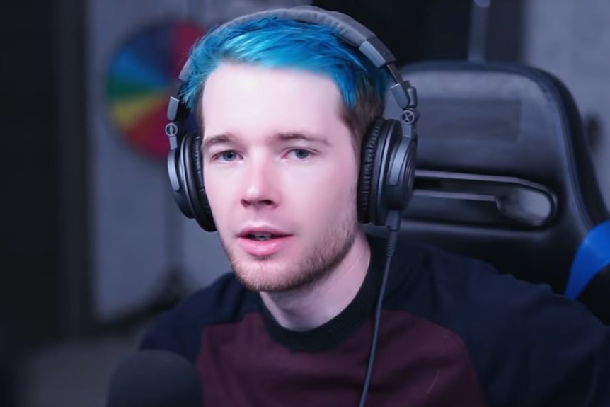 DanTDM wears headphones and games in one of his YouTube videos.