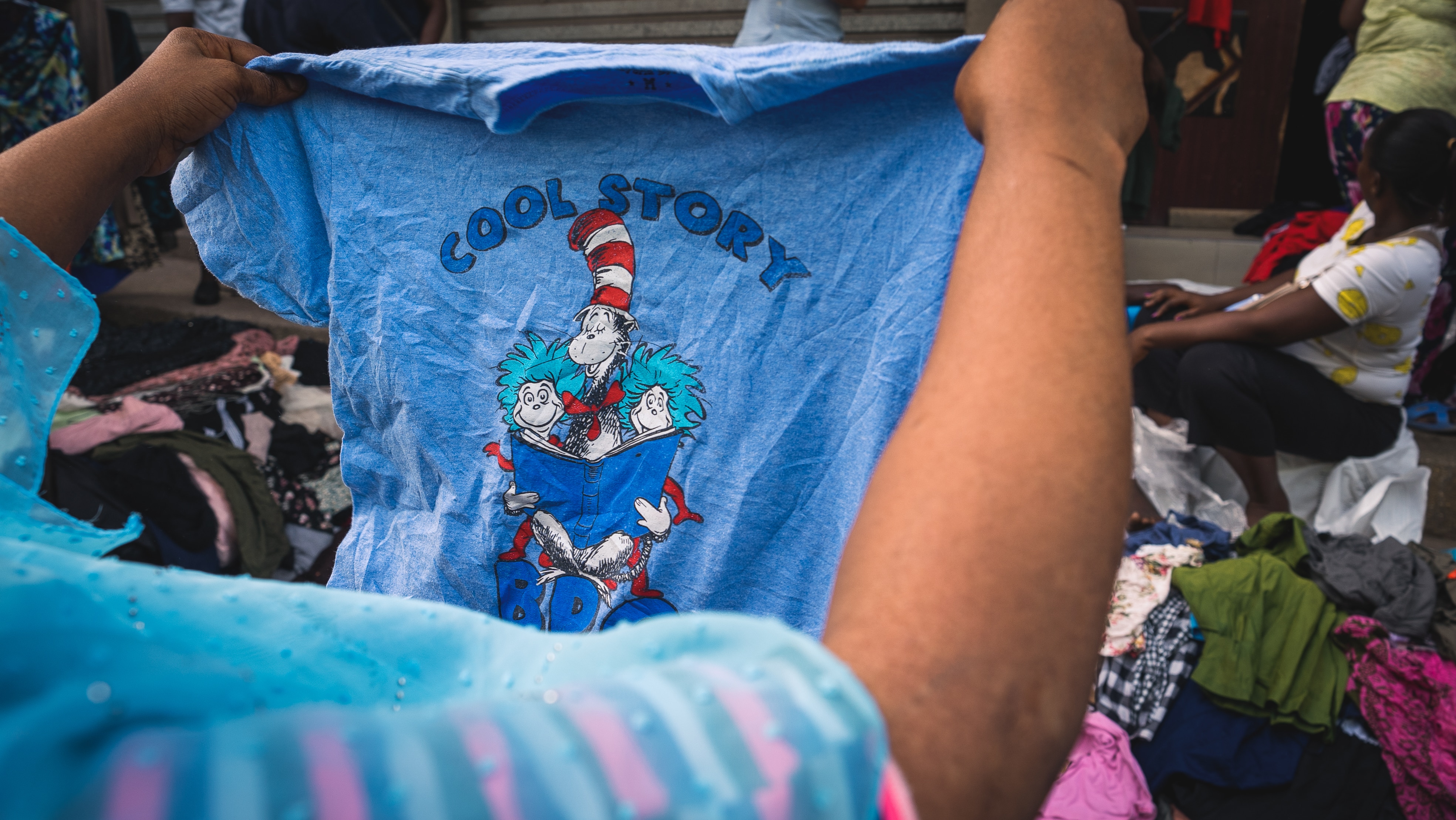 A blue t-shirt being held up.