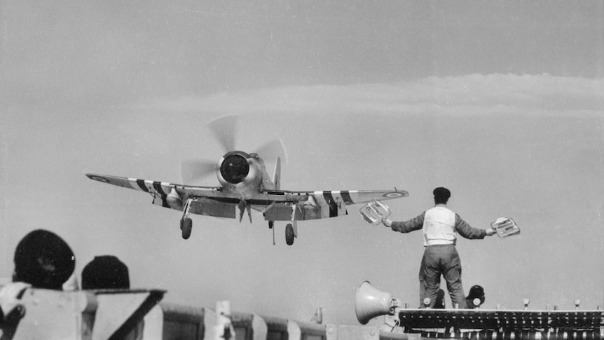 A black and white image of a plane landing during the war.