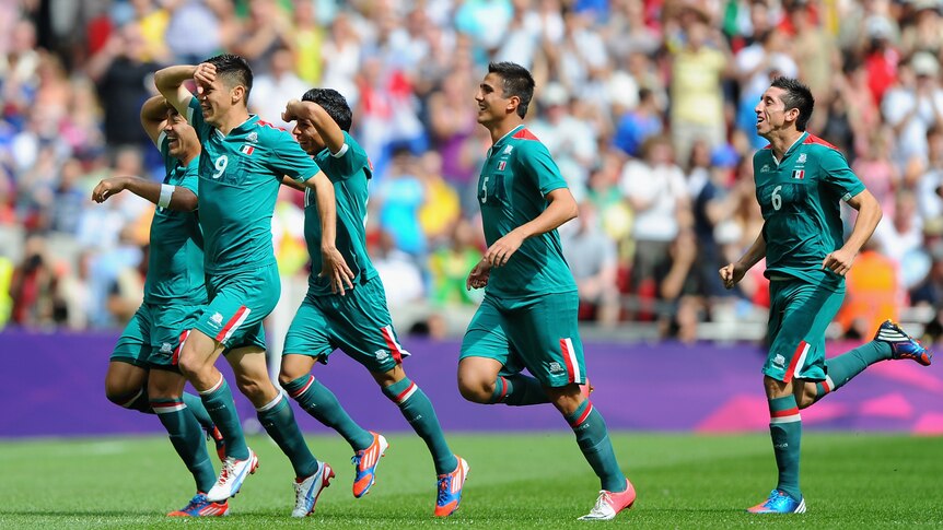 Oribe Peralta celebrates after scoring the opening goal of Mexico's 2-1 over Brazil.