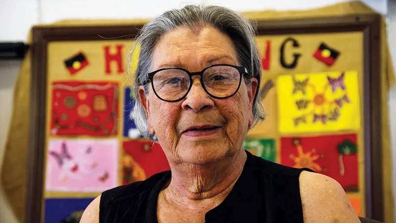 A First Nations woman smiles at the camera