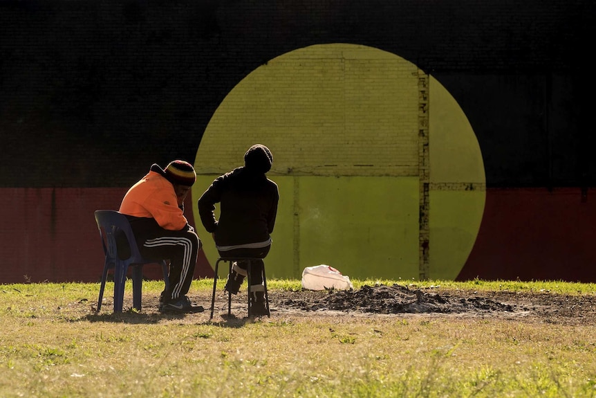 Robert Lomas and Simone Davidson sit in the sunshine