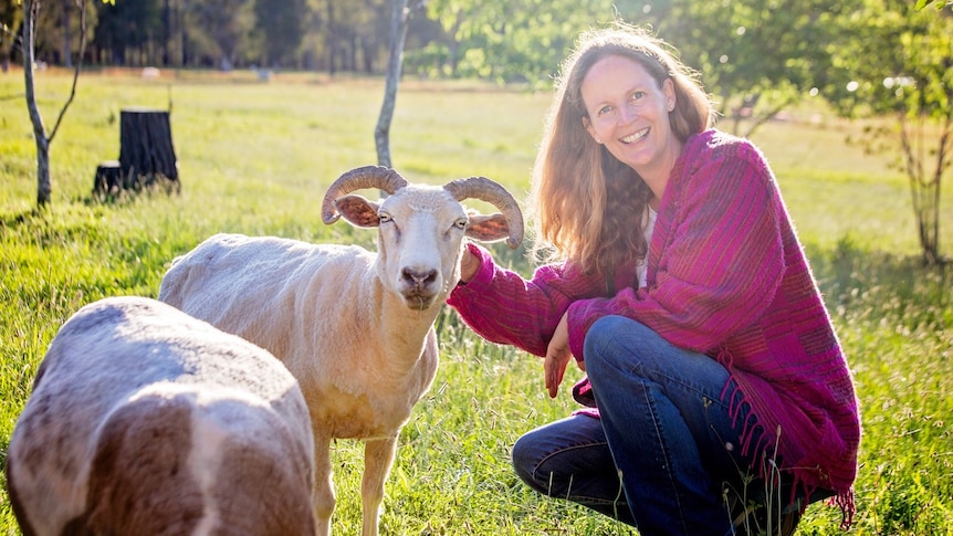 Anna Featherstone with goats on her mixed farming property.