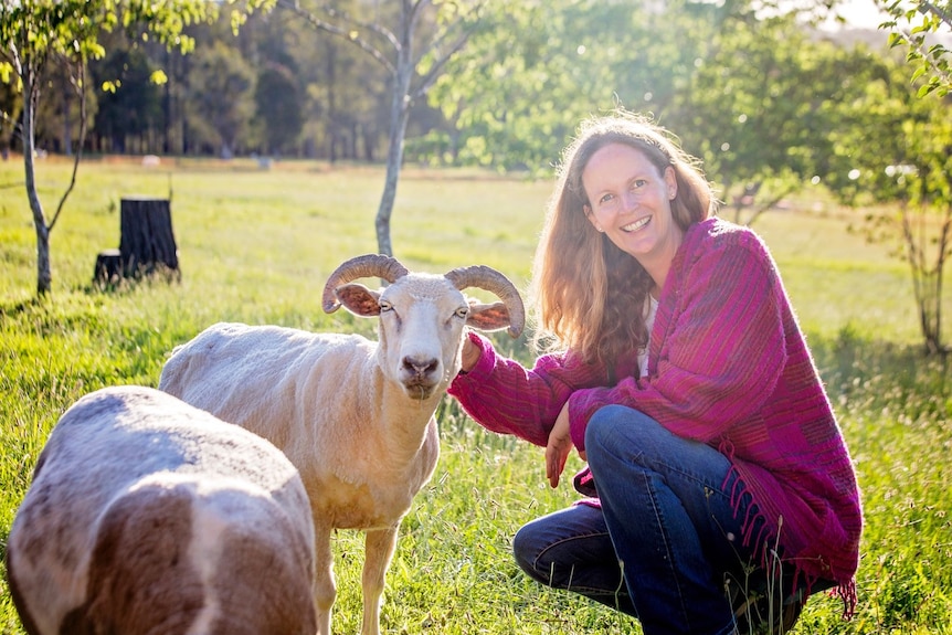 Anna Featherstone with goats on her mixed farming property.