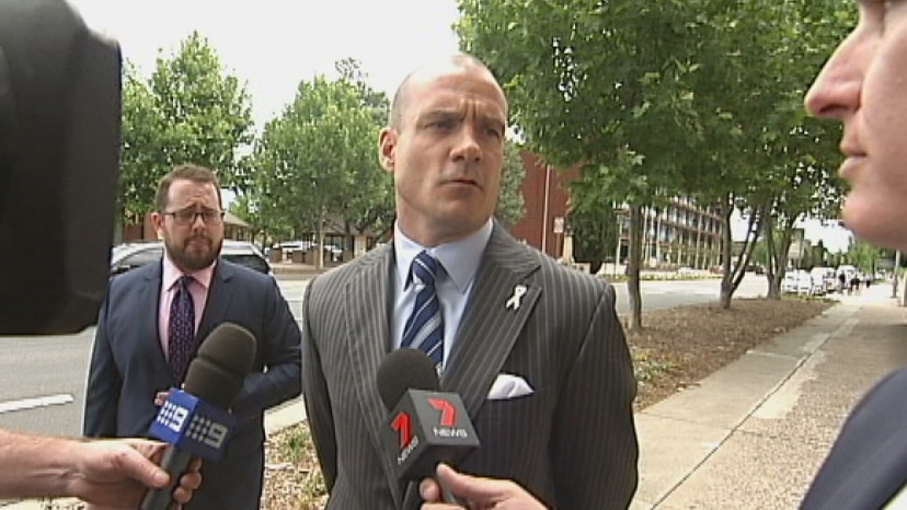 Hastings Fredrickson (centre) told the media outside the Queanbeyan police station he intends to fight the charges.