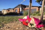 Flowers left at the home on Bittermann Street in Jacka