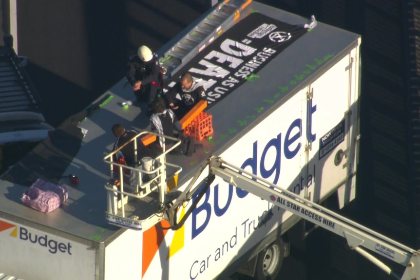 Protesters on top of a truck