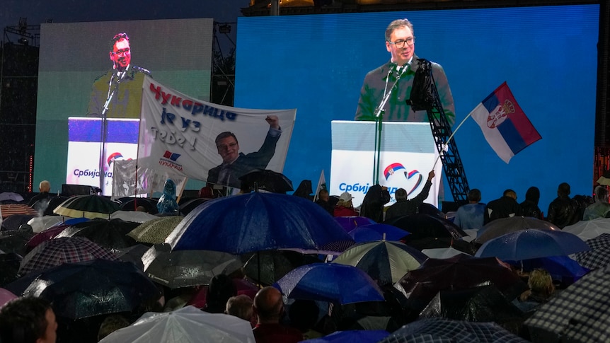 Serbian President Aleksandar Vucic  is seen on a big screen as he speaks during a rally in front of the Serbian parliament.