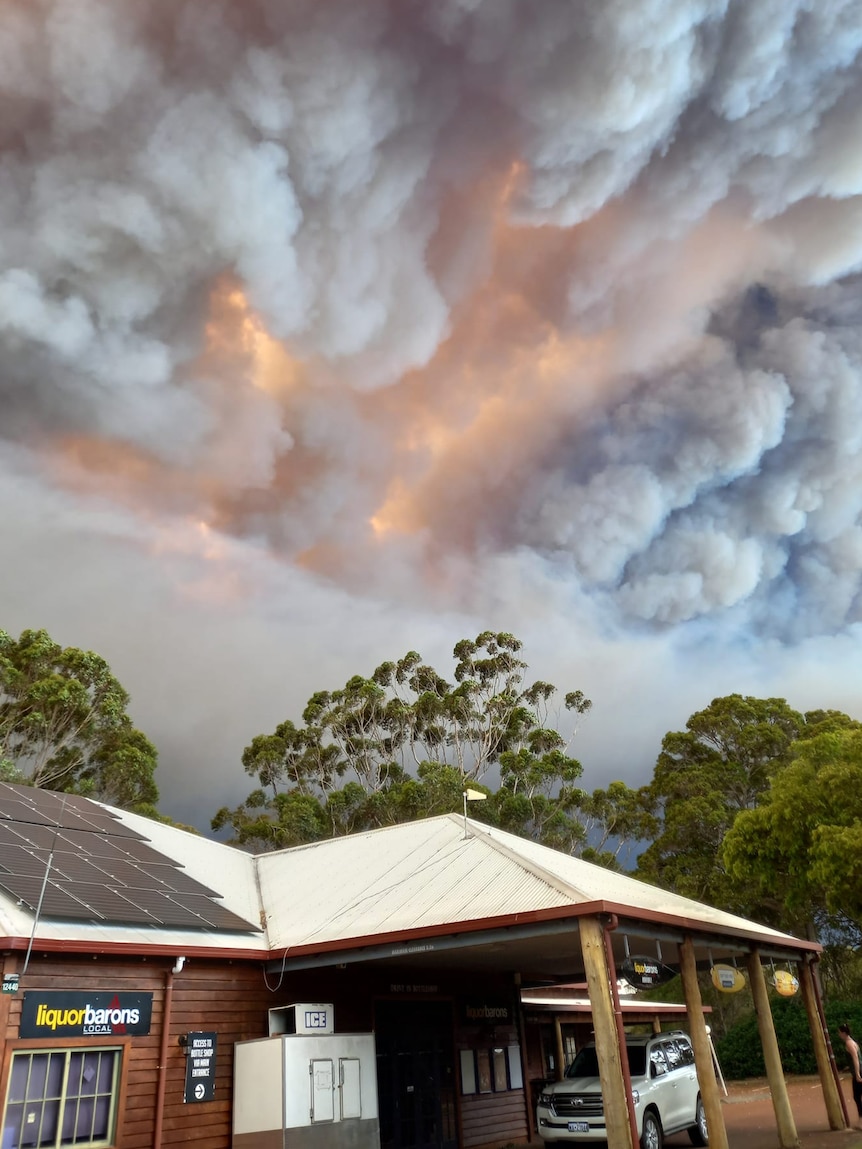 Thick smoke in the sky above a tavern.