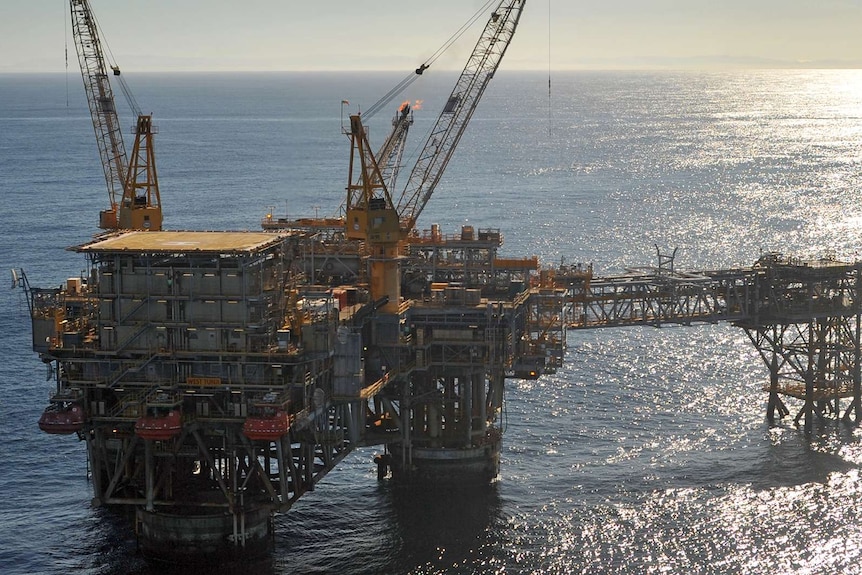 An offshore oil rig standing in the ocean.