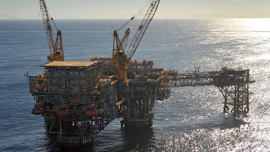 An offshore oil rig standing in the ocean.