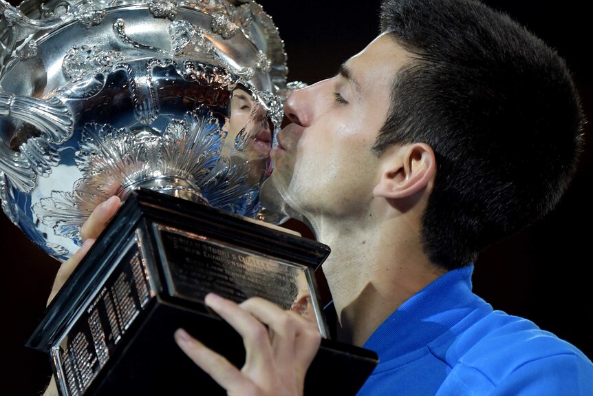 Djokovic kisses the trophy after winning Australian Open