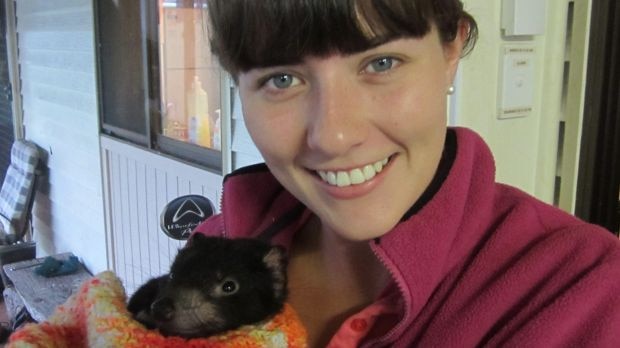 Researcher Emma Peel with a Tasmanian devil joey.