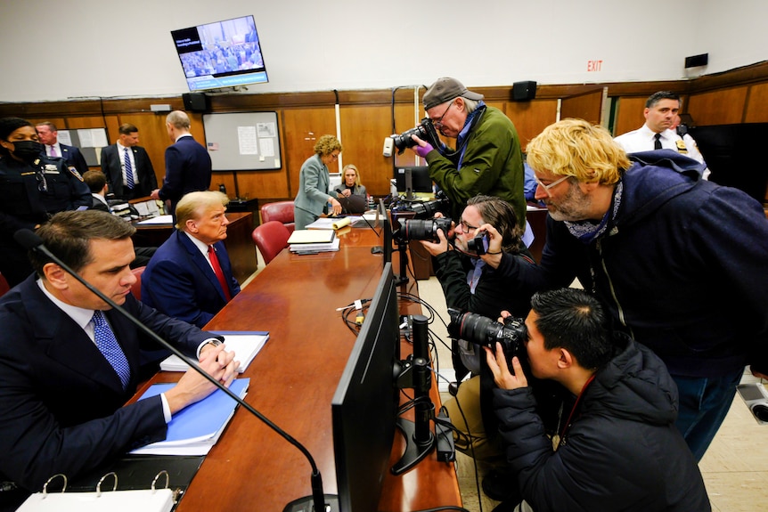 Court photographers take Donald Trump's photo in court.