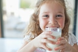 Picture of little girl smiling and drinking milk