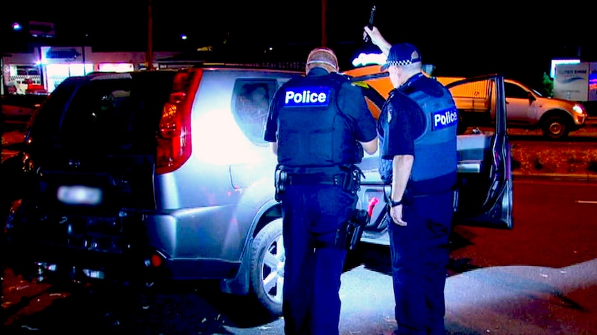 Police inspect a stolen car in Frankston.