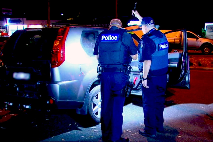 Police inspect a stolen car in Frankston.