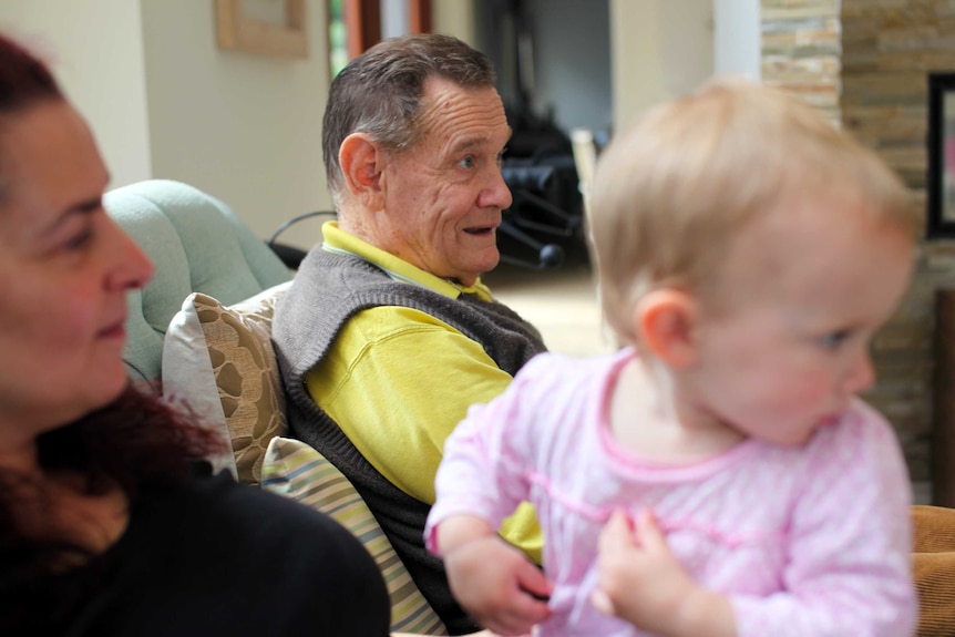 Geoff Southam and baby Isabella at 'story time'.