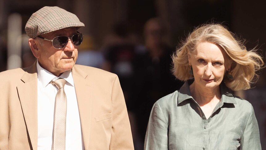 Don Spiers wearing a tan jacket and flat cap and Carol Spiers wearing a khaki dress outside court.