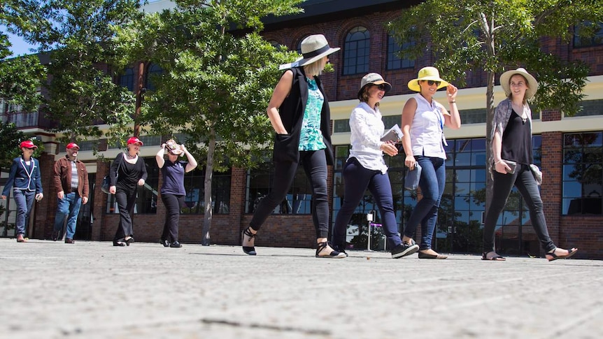 Office workers from nearby offices come together to walk to local cafes.