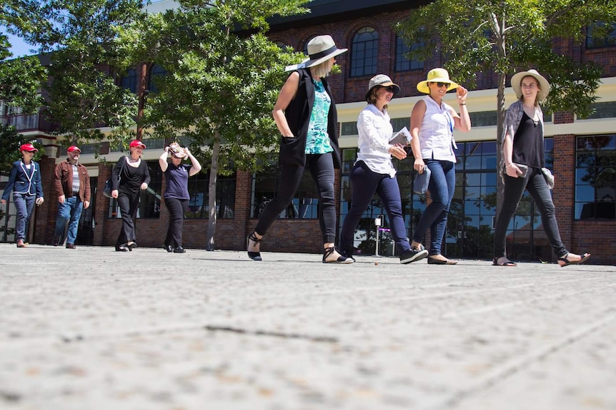 Office workers from nearby offices come together to walk to local cafes.