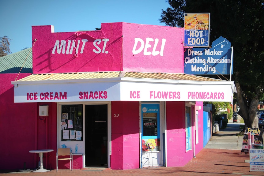 A bright pink deli on a neighbourhood street corner