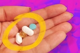 Hand holding pills and vitamins for a story with advice about how to make the most of vitamins