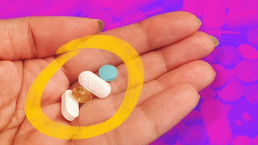 Hand holding pills and vitamins for a story with advice about how to make the most of vitamins