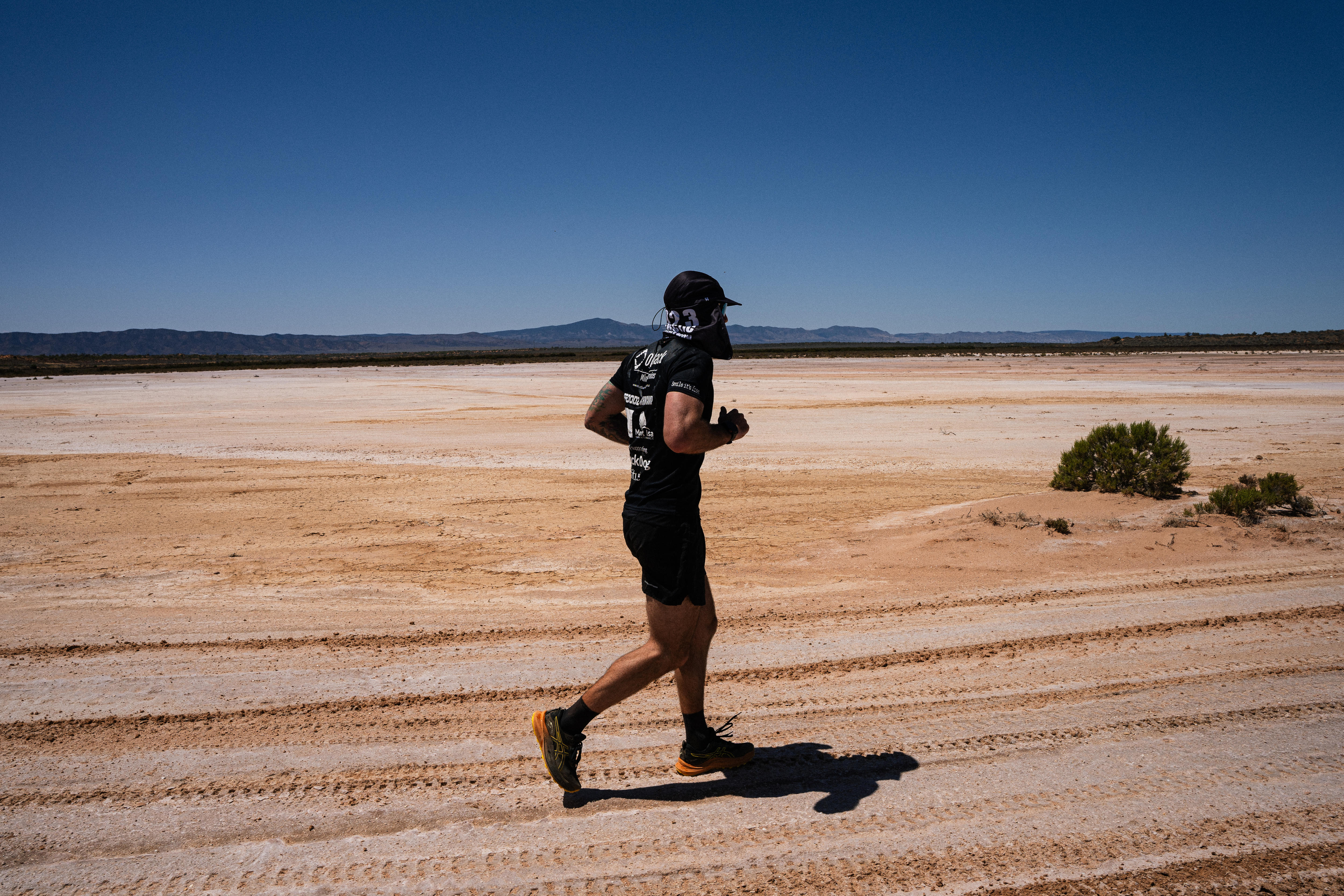 Man runs across salt plains. 