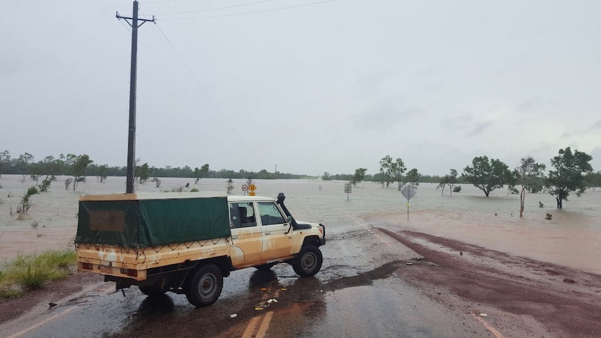 a ute next to a flooded river