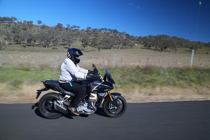 A person riding a motorbike on a country road