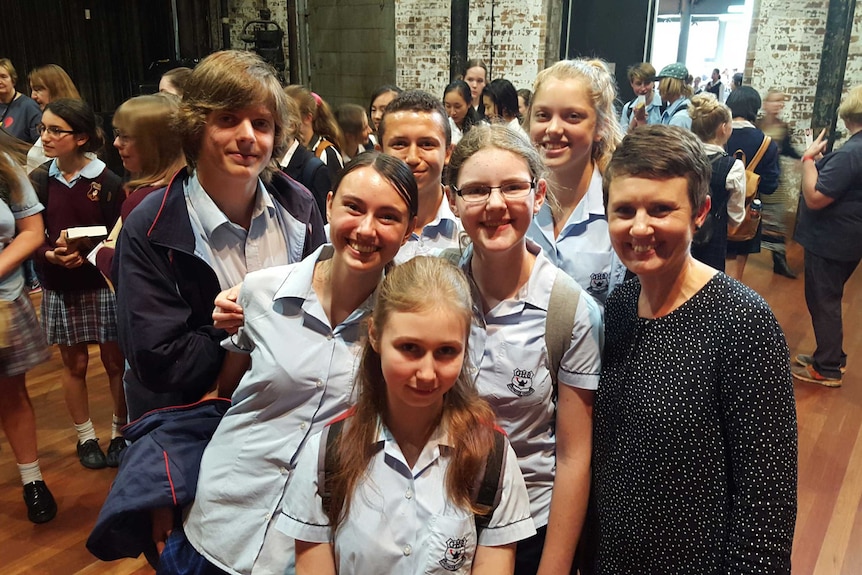 Six Gosford High School students and a teacher smile at the camera.