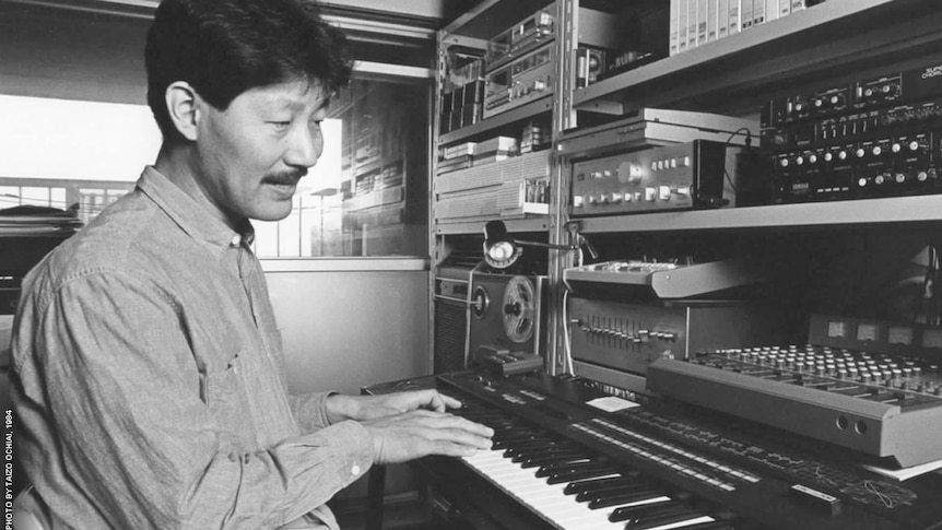 Black-and-white archival photo of musician Hiroshi Yoshimura.