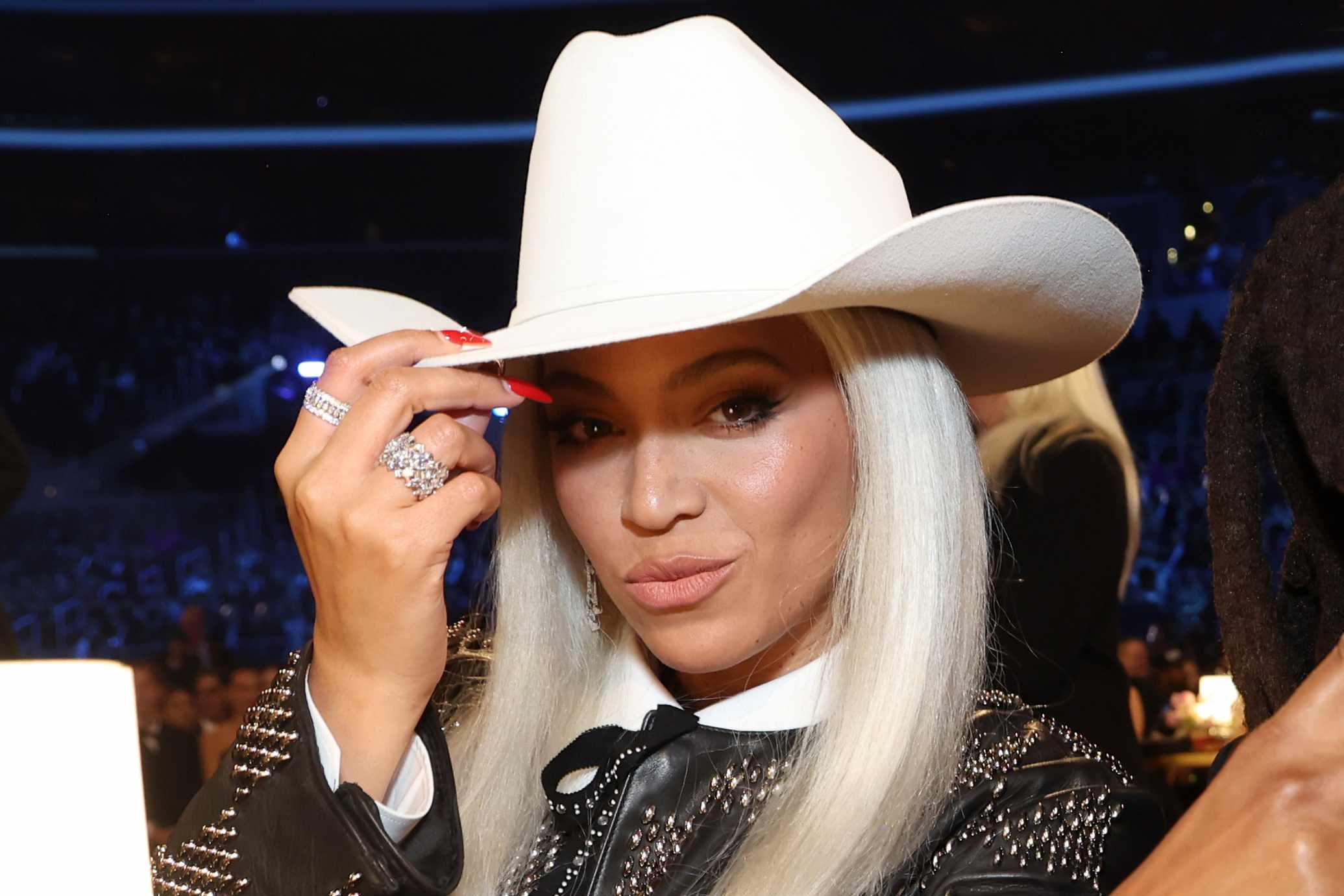 Close-up of Beyonce wearing a white cowboy hat 