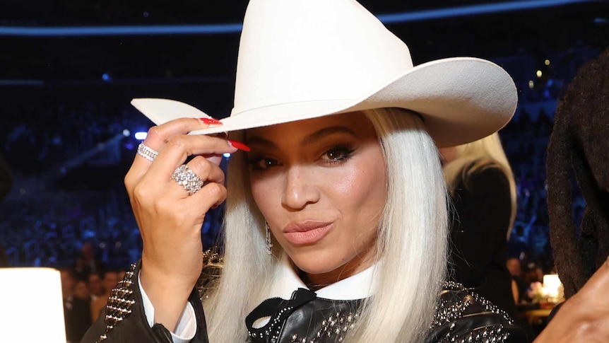 Close-up of Beyonce wearing a white cowboy hat 